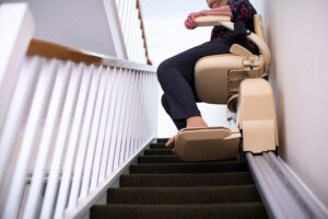 Persona mayor utilizando un sillón elevador en una escalera